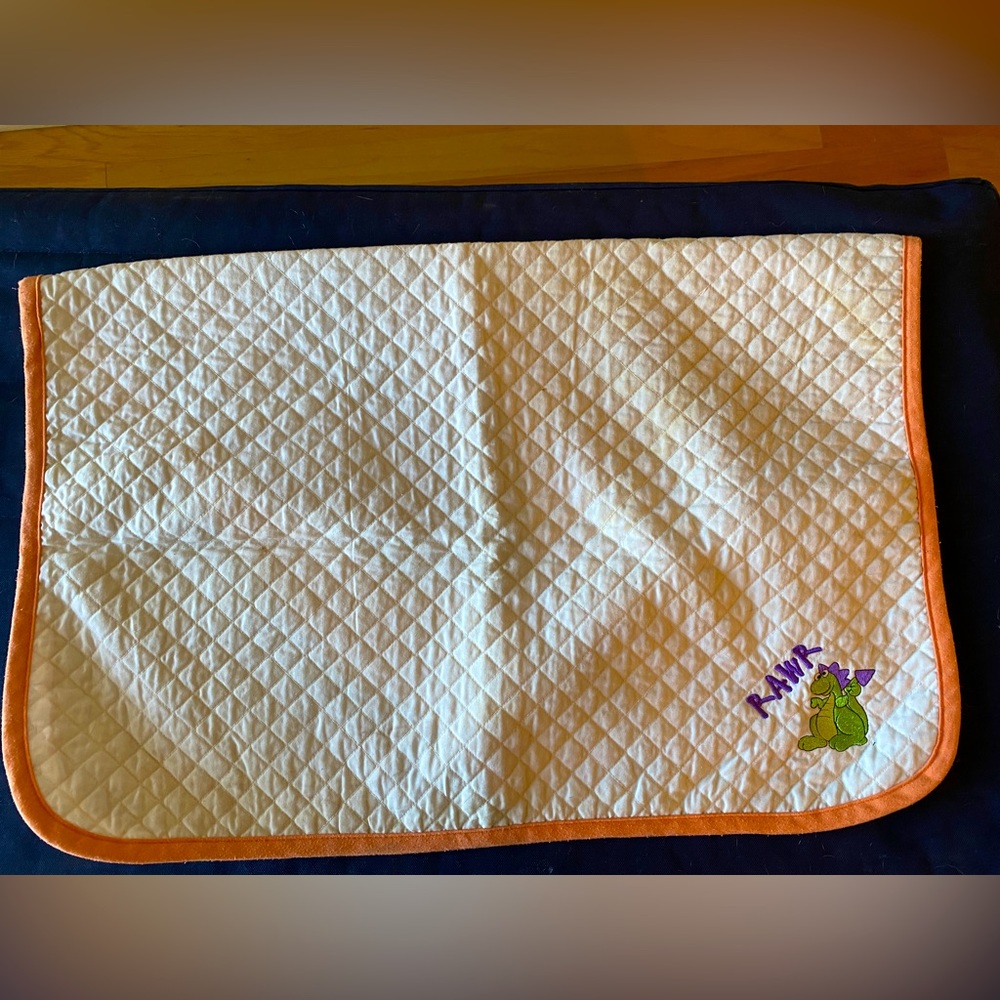 Orange and white saddle pad with monogram